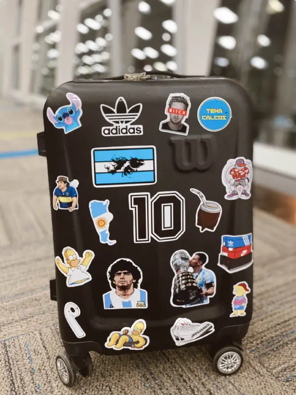 Valija negra con stickers argentinos y de fútbol